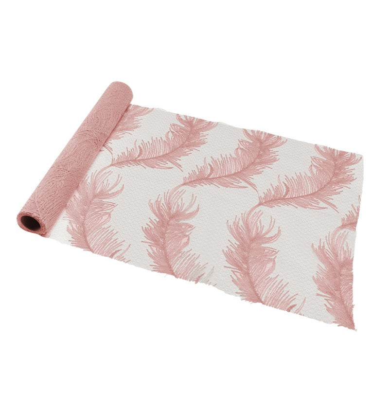 The image shows a powder pink table runner with a delicate, feathery texture, unrolled across a table, suitable for party or event decoration.