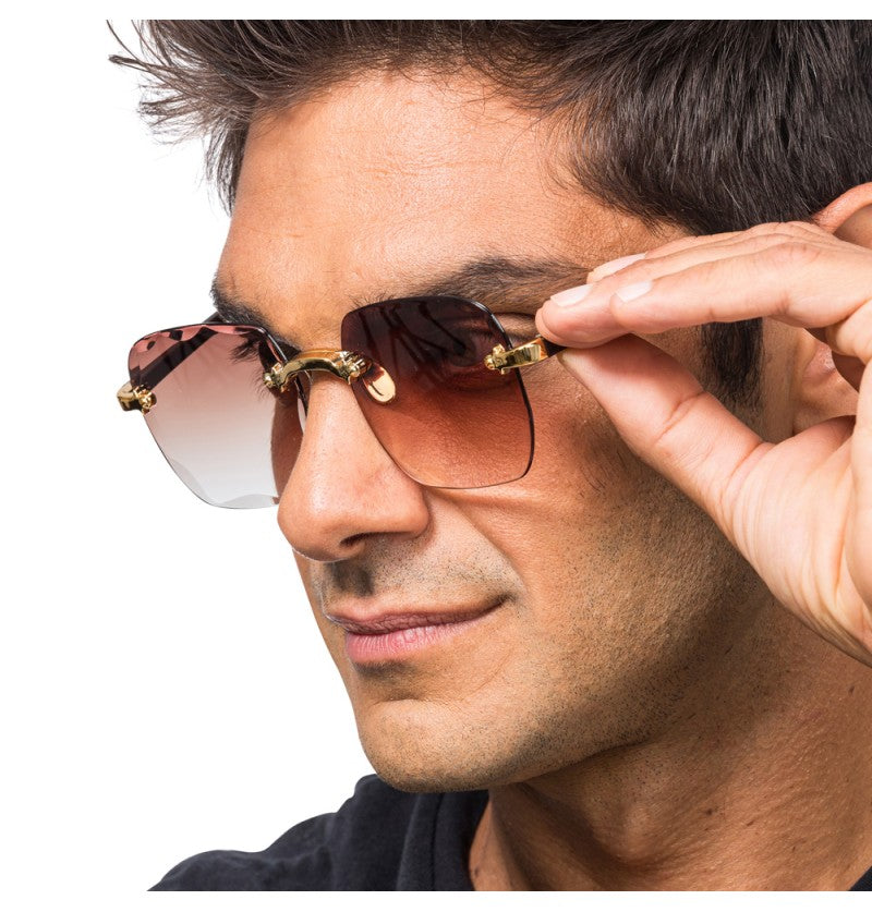 The image shows a pair of rimless sunglasses with brown-tinted lenses, measuring approximately 15cm x 14cm x 5.