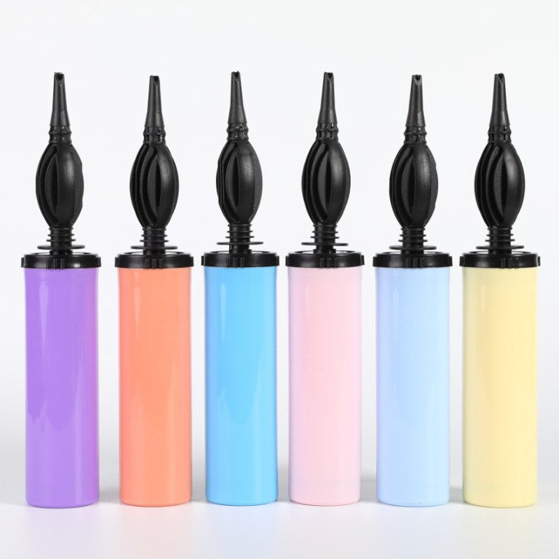 The image shows a balloon pump with a dual-action (push-pull) mechanism, designed for inflating balloons.