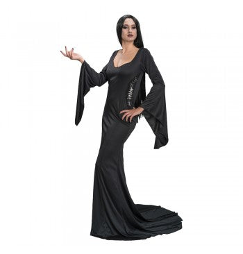 The image shows a person dressed in a long, black, gothic-style dress reminiscent of Morticia Addams or Wednesday Addams from the Addams Family, with a fitted bodice and flared sleeves, suitable for a Halloween or costume party.