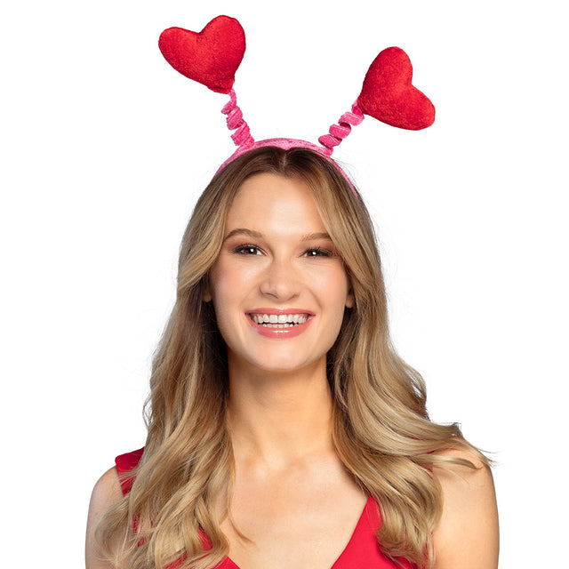Red tiare headband for women featuring waving heart designs, made of polyester and polypropylene, ideal romantic accessory for adults.