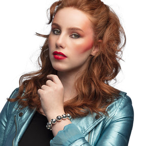 Silver disco ball bracelet for women, 80s inspired jewelry accessory made of ABS and rubber, perfect for adult party outfits.