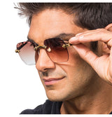 The image shows a pair of rimless sunglasses with brown-tinted lenses, measuring approximately 15cm x 14cm x 5.