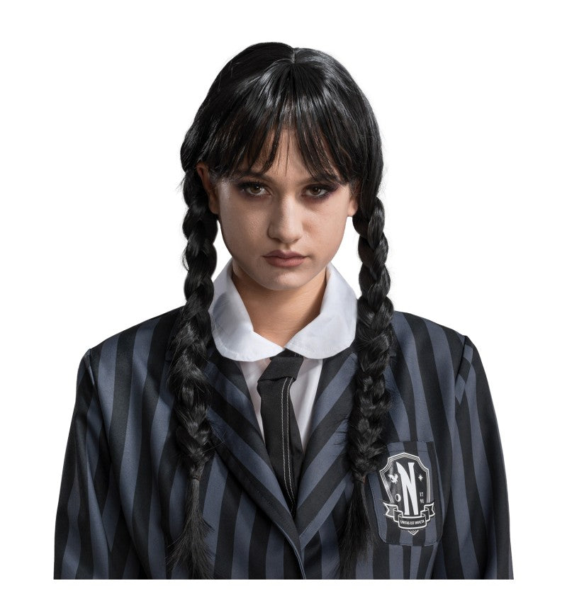 The image shows an adult wearing a black braided wig styled to resemble Wednesday Addams from the Addams Family, with a dark outfit and a white collar, evoking a classic Halloween or costume party theme.